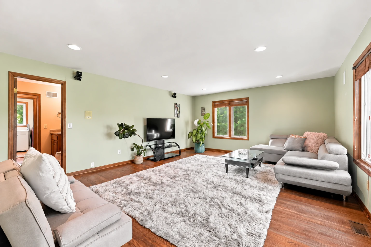Bright family room with broad windows and a comfortable seating area