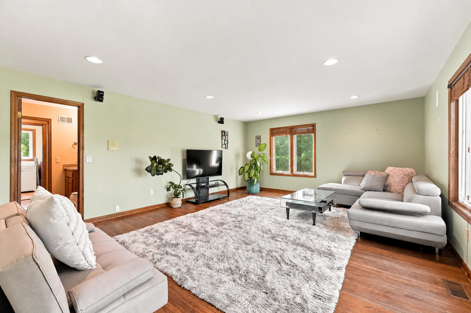 Bright family room with broad windows and a comfortable seating area